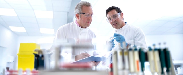 Scientists Discussing Test Results in Laboratory